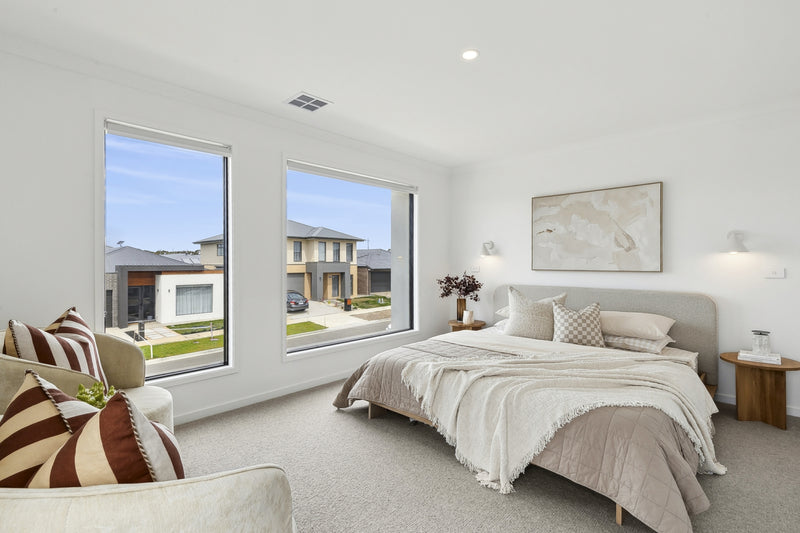 Neutral bedroom styling for home staging featuring a soft upholstered bed, layered linen, minimal artwork and natural light to create a calm, buyer-focused retreat.