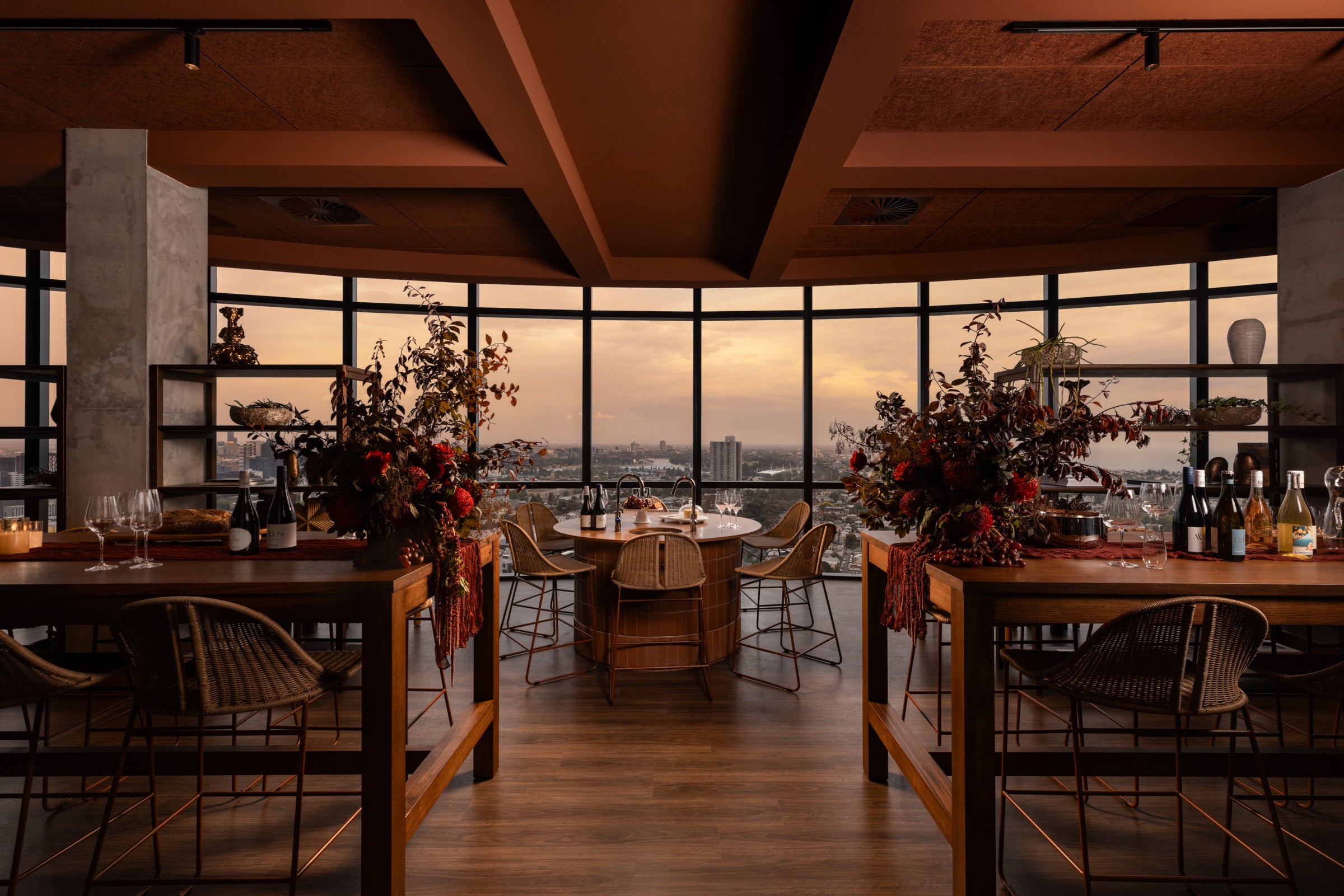 Embestro Interiors commercial property styling of a luxury wine room in Melbourne with timber furniture, ambient lighting, rattan seating and autumn florals.